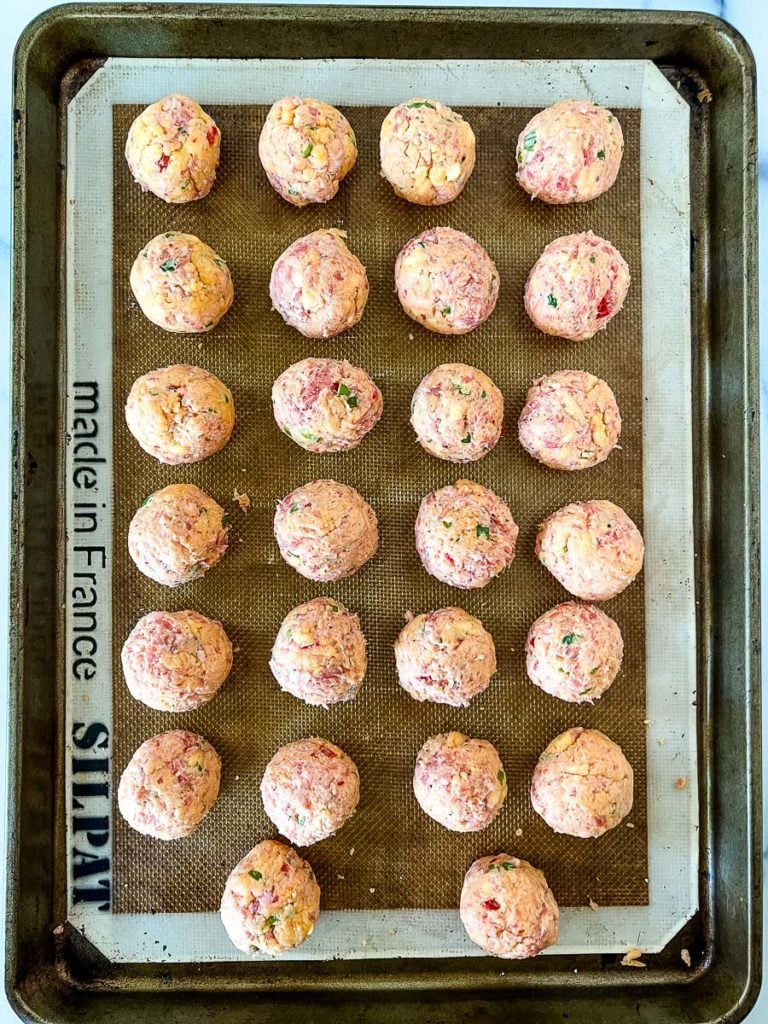 a baking sheet with palmetto cheese sausage balls ready to bake