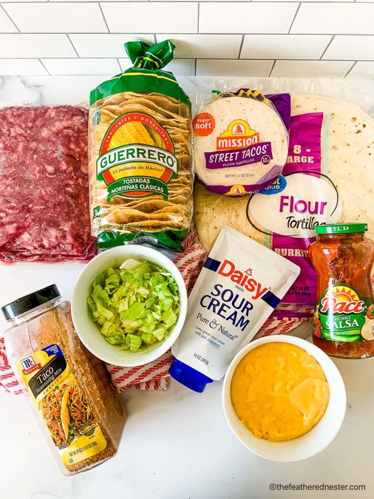 ingredients for copycat blackstone cruchwrap recipe includes ground beef, tostadas, small and large flour tortillas, taco seasoning mix, lettuce, sour cream, cheddar cheese and salsa