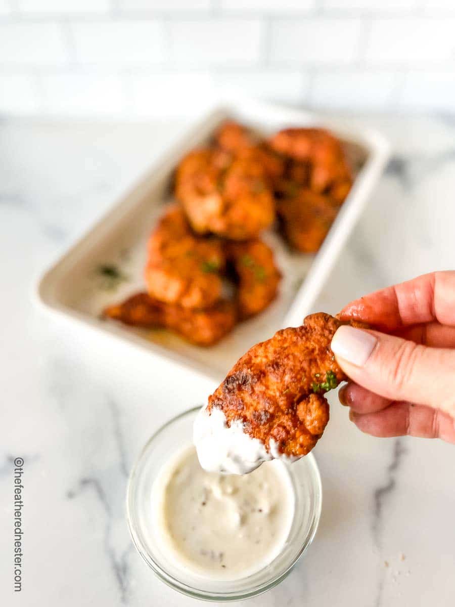 Nashville chicken tenders dipped in blue cheese dressing.