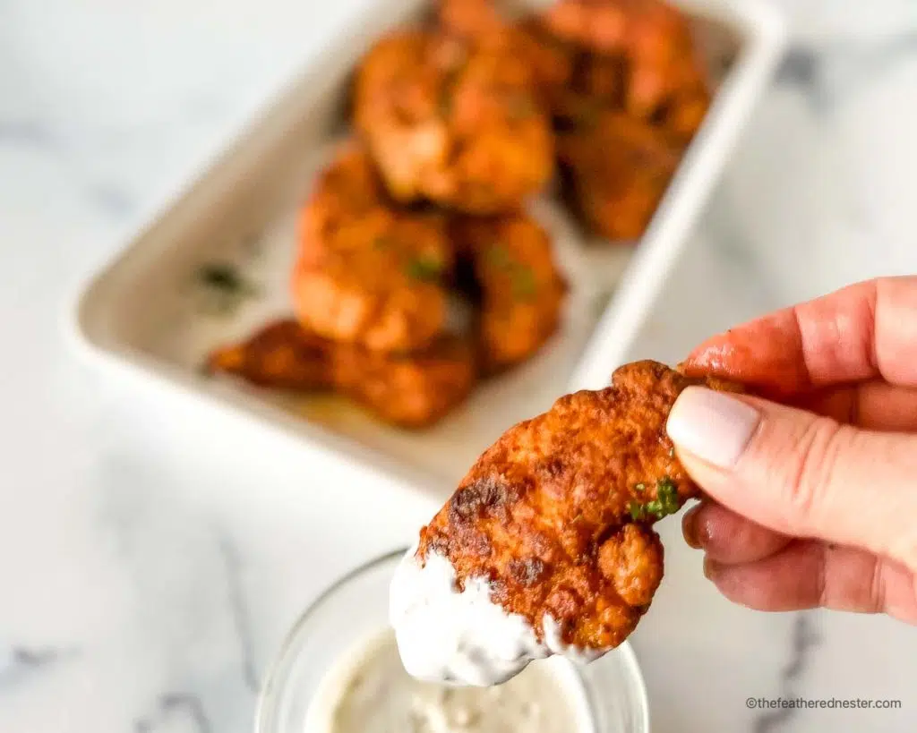 Nashville chicken tenders dipped in  a blue cheese dressing
