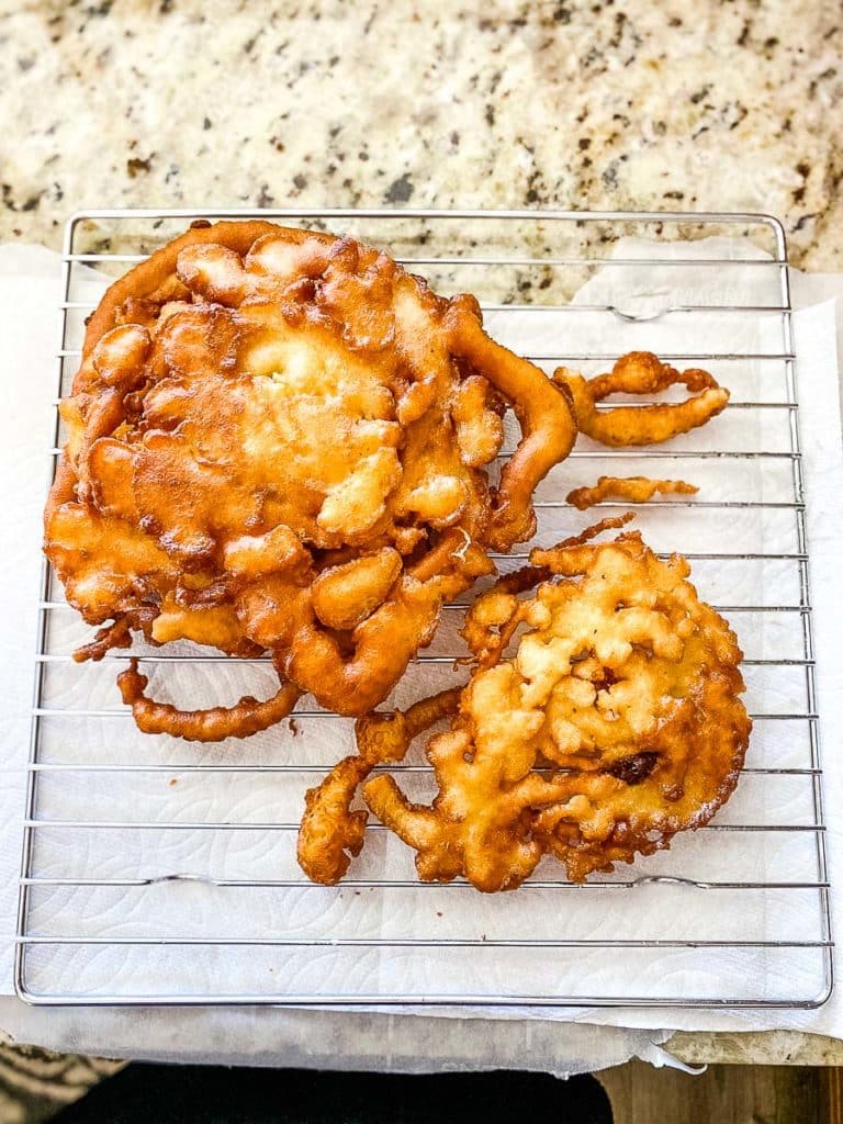 Bisquick funnel cakes in a cooling rack.