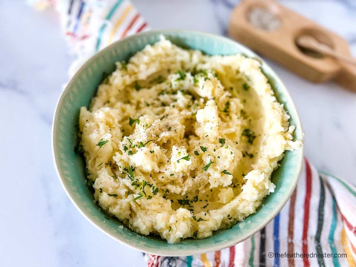 Red potato side dish in a green serving bowl.