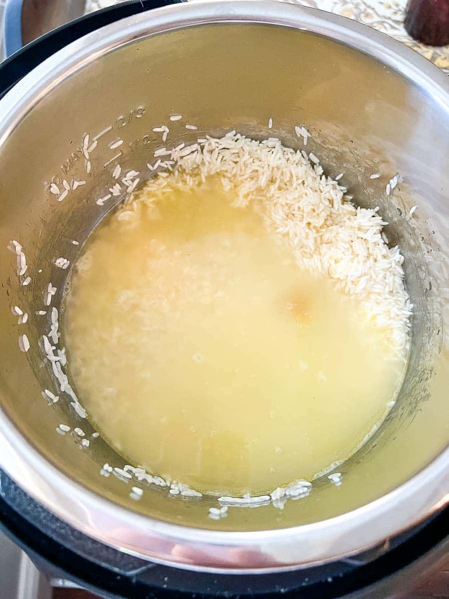Chicken broth and Jasmine rice ready to cook in the Instant Pot.