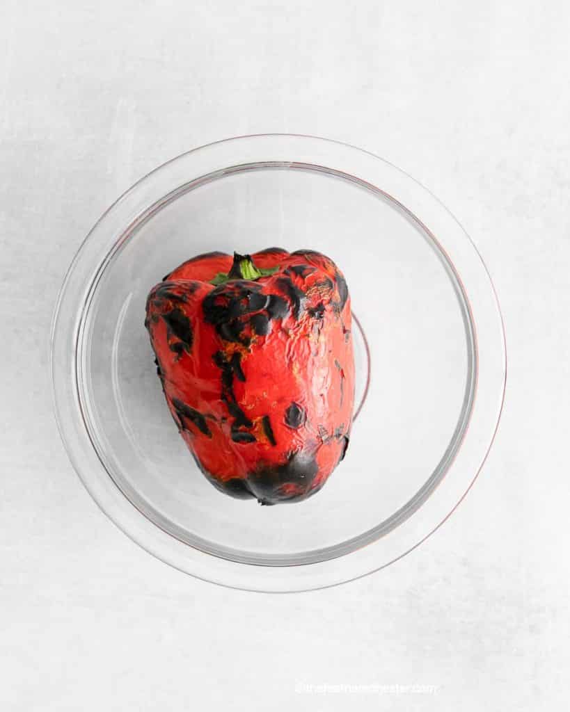 Roasted red pepper placed in a clear bowl.