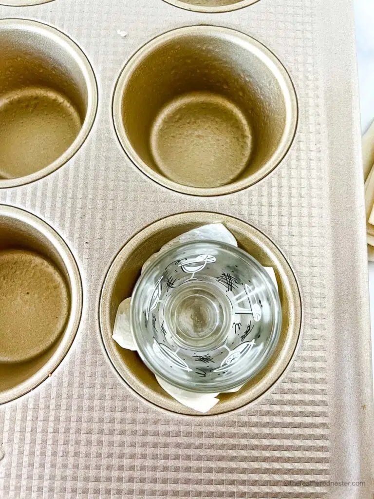 muffin pans with wonton wrappers and being shaped by a shot glass.