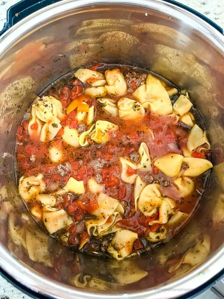 cooked Tortellini Soup inside the pressure cooker.