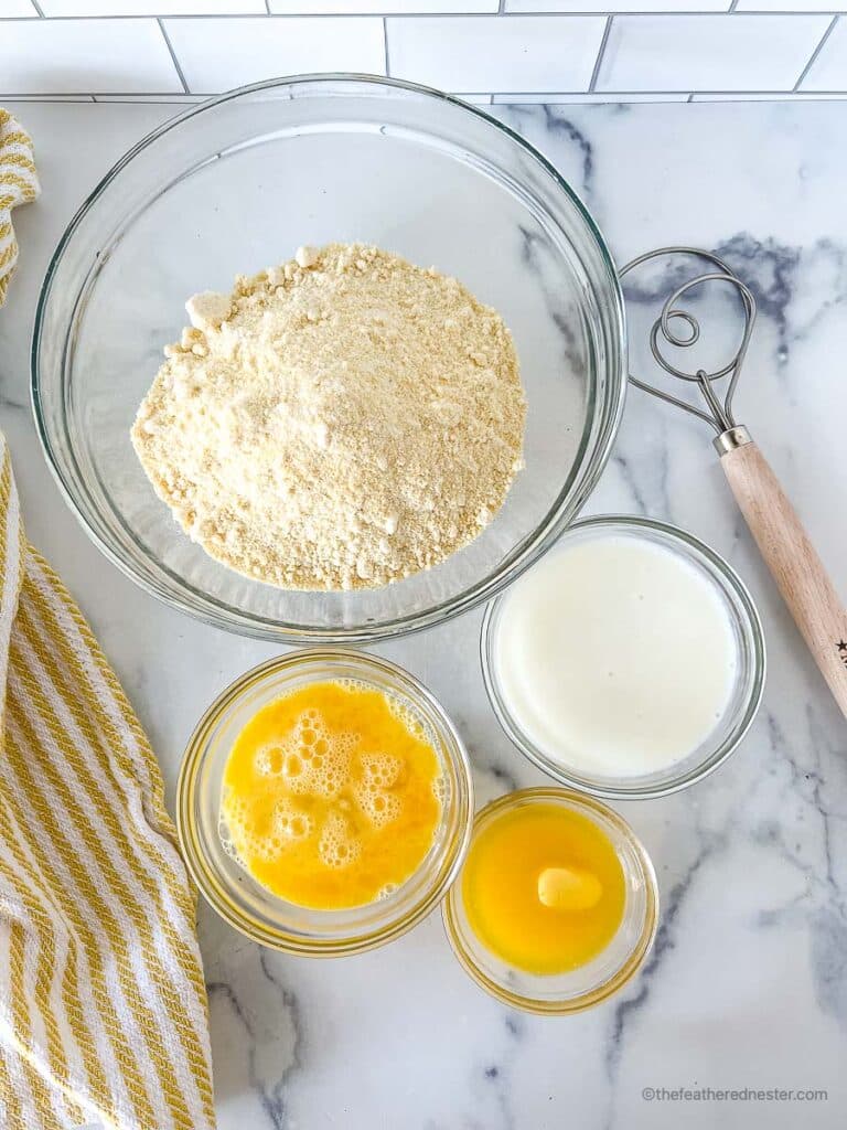 ingredients for making Jiffy cornbread with buttermilk which contains Jiffy corn mix, beaten eggs, buttermilk, and a melted butter.