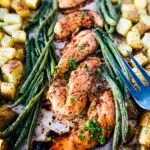 oven baked marinated chicken tenders with asparagus and potatoes beside it.