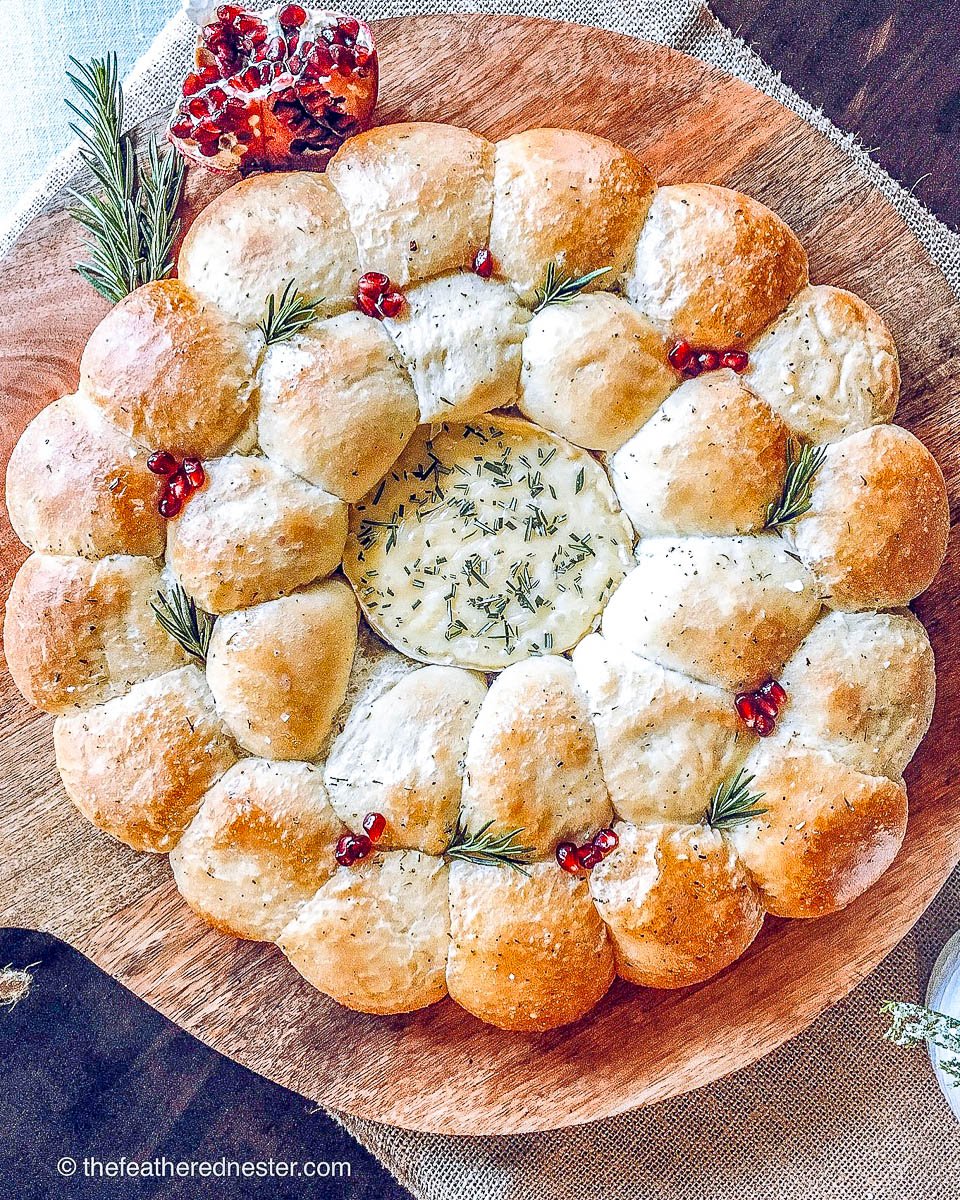 bread rolls in a circle around camembert cheese as a Christmas wreath