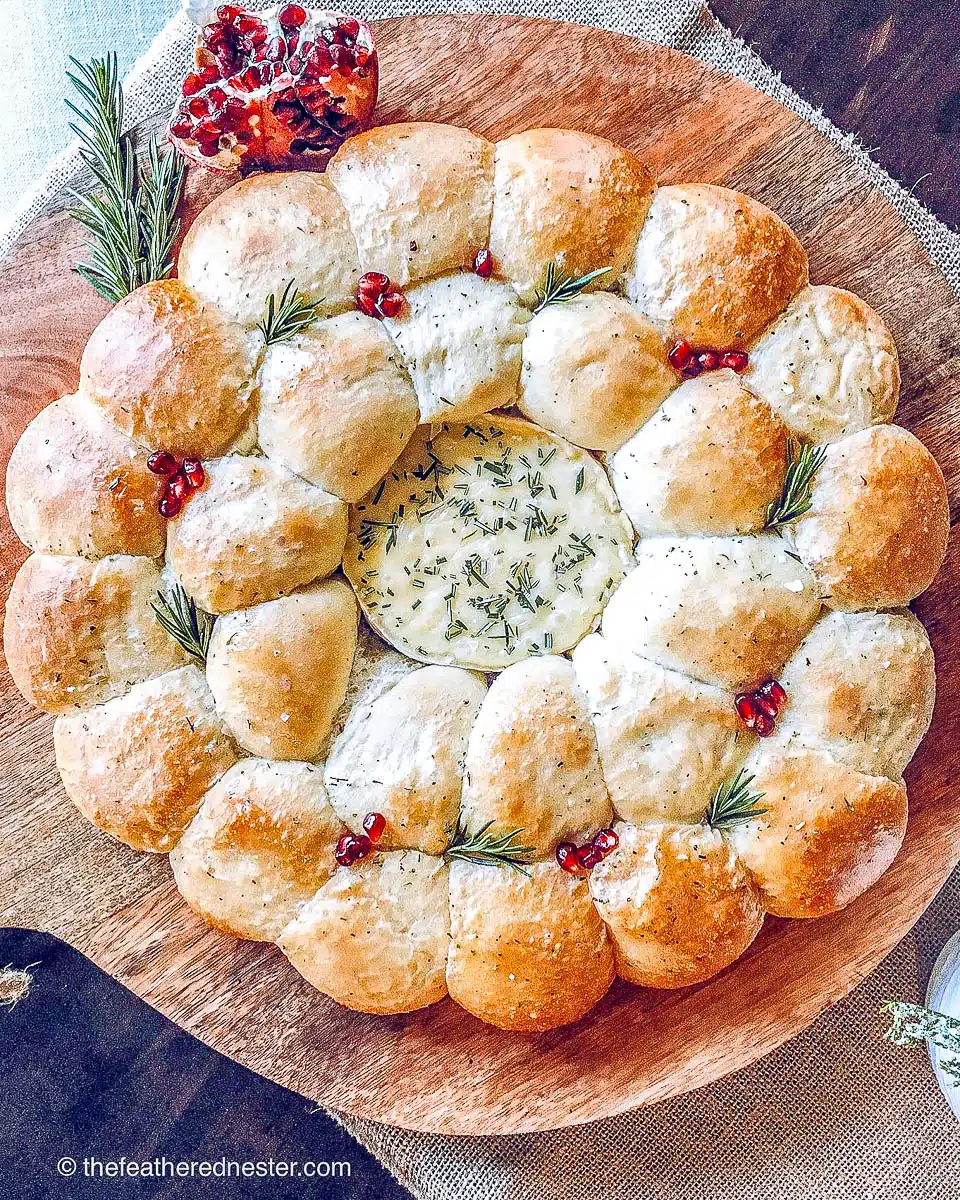 bread rolls in a circle around camembert cheese as a Christmas wreath