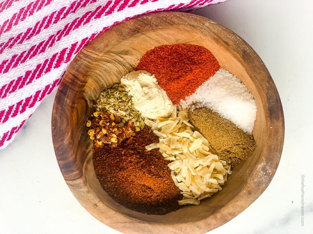 homemade chicken taco spices ingredients all placed in a wooden bowl.
