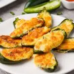 baked stuffed jalapeno poppers on a white plate.