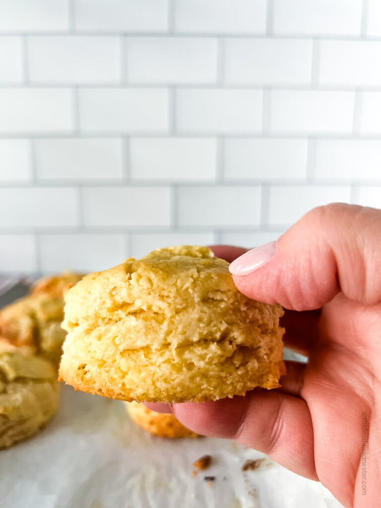 a hand holding a Bisquick buttermilk biscuit.