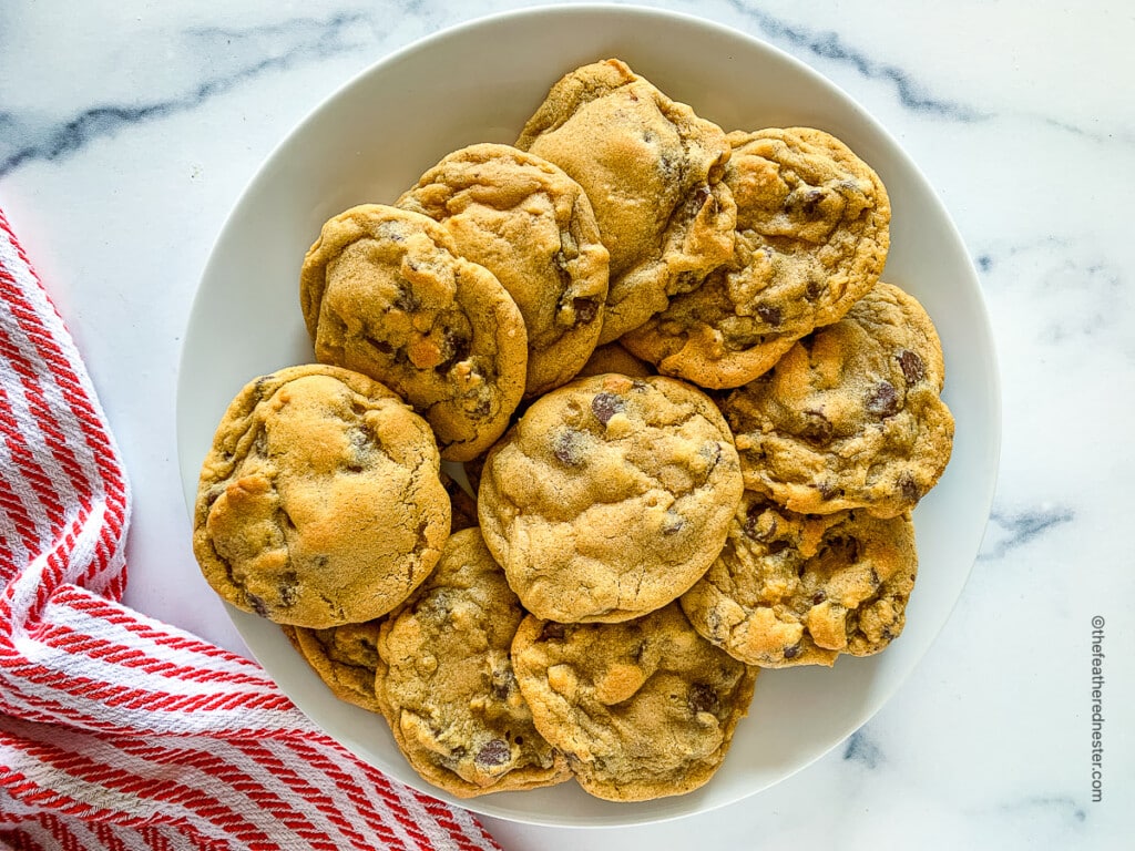 a white plate full of no brown sugar chocolate chip cookies.