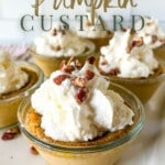 six cups of pumpkin custard and with whipped cream and nuts on top. with writings on top and bottom