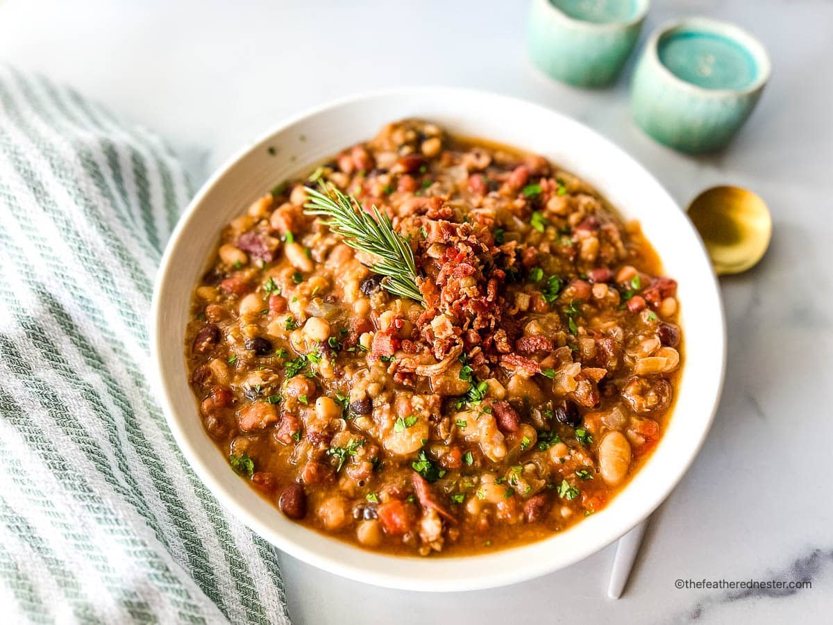 A bowl of 15 bean soup with kitchen items on the side