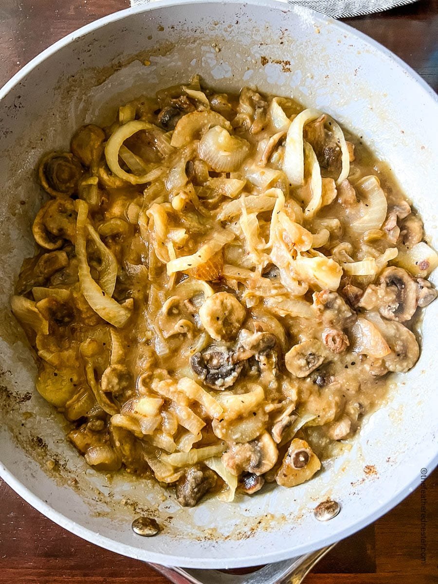 mushroom and onion gravy in a skillet.