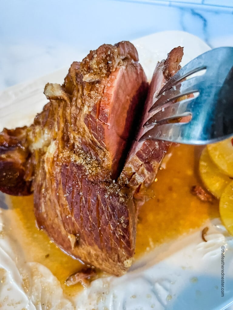 close up of carving fork in spiral sliced meat.