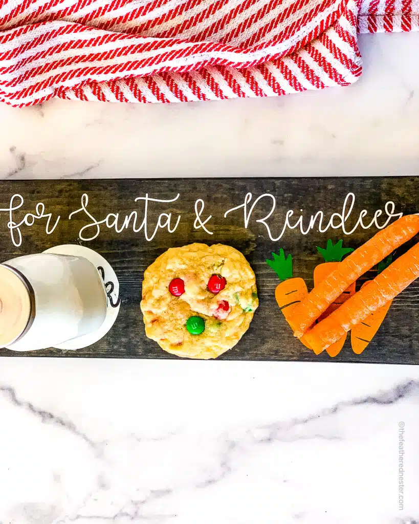 a board for Santa with a jug of milk, a cookie, and carrots for the reindeer