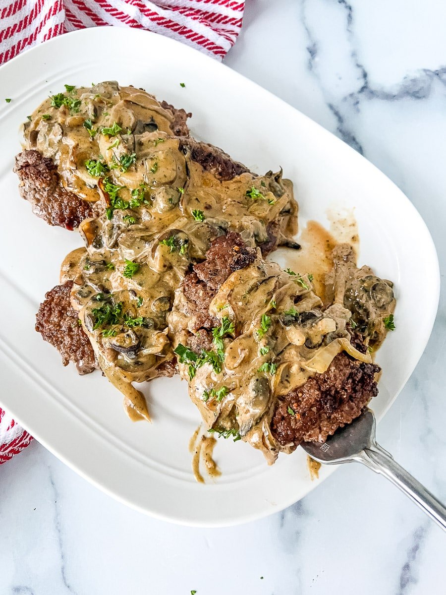 A platter of crock pot cube steak being served.