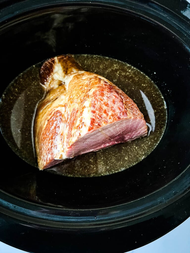 Ham placed inside the slow cooker.