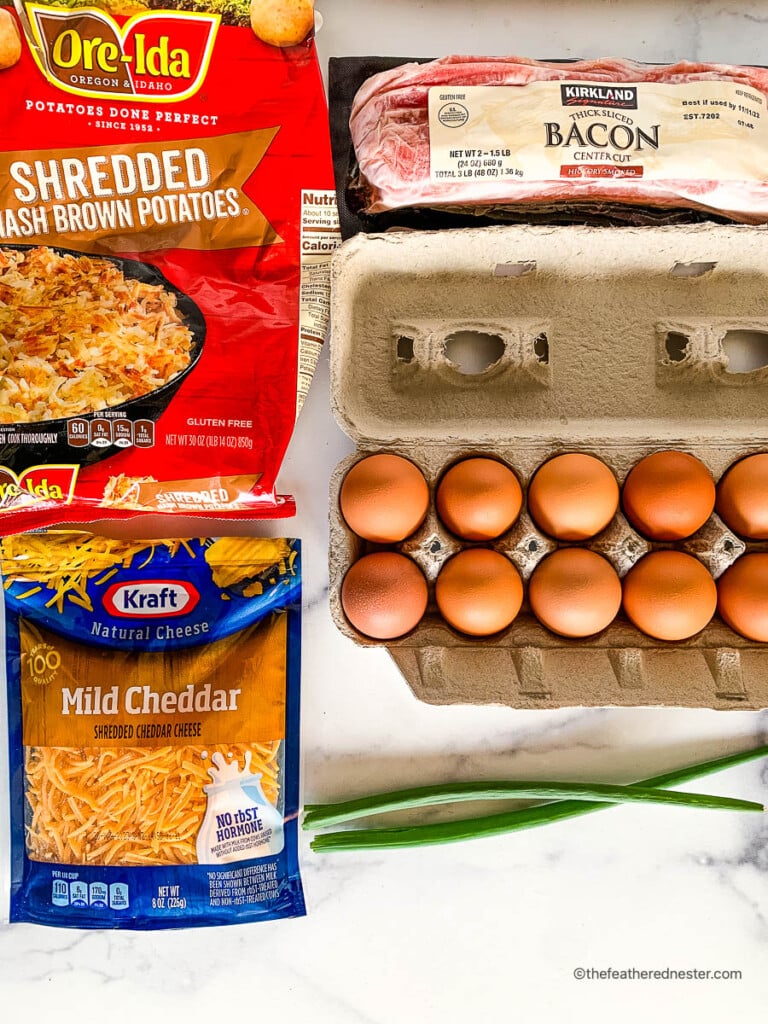Packages of shredded hash brown potatoes, bacon, eggs and shredded cheddar cheese, for making an egg nest recipe.