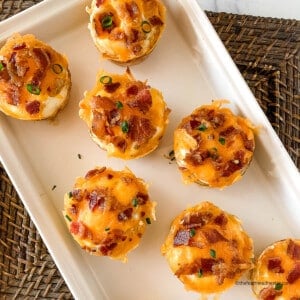 square photo of a white tray with hash brown breakfast cups.