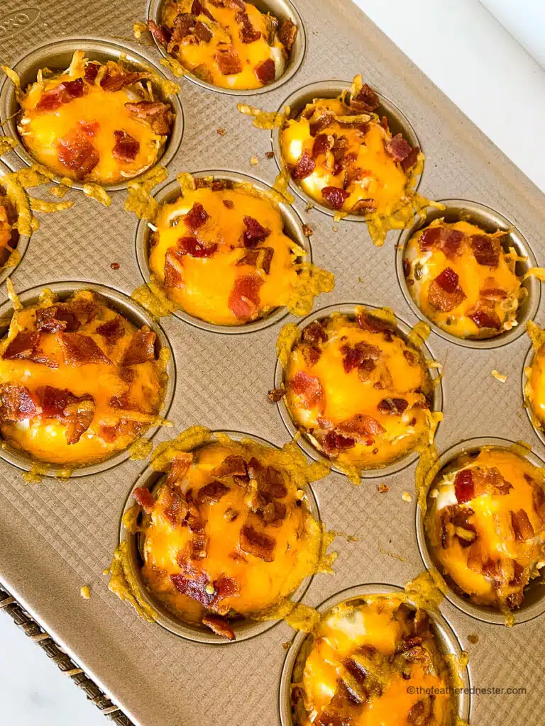 baked hash brown birds nest egg cups in a muffin pan.