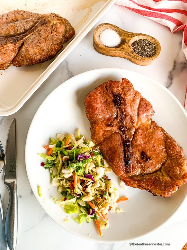 Plated dinner of meat and salad.