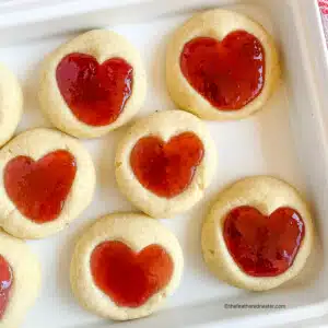 Cute heart jam cookies on a white platter.