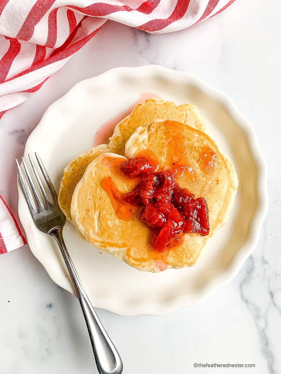 Table set with romantic breakfast of pancakes for 2.