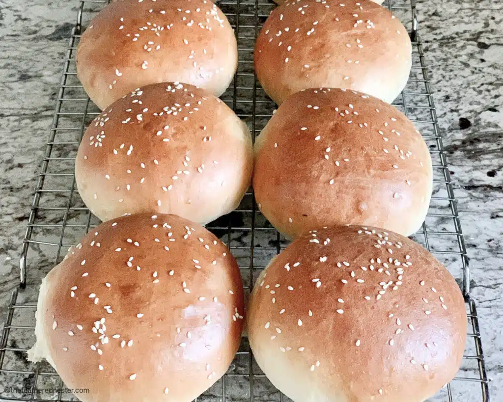 sesame seed buns on a cooling rack.