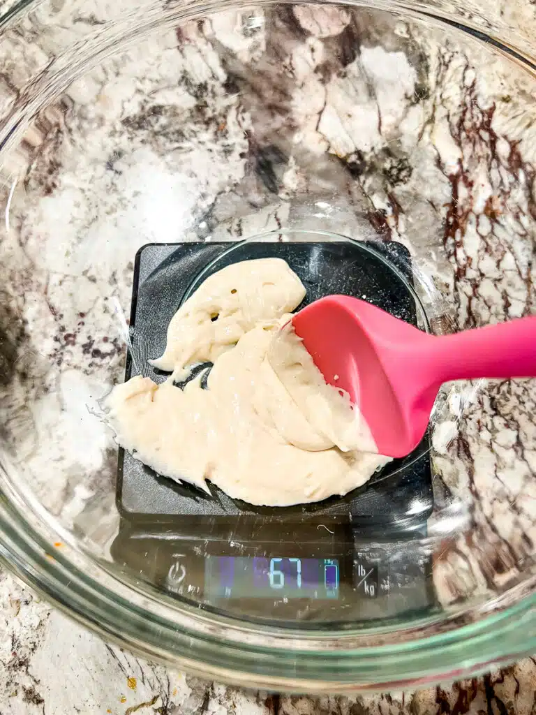 weighing bread dough on a digital kitchen scale.