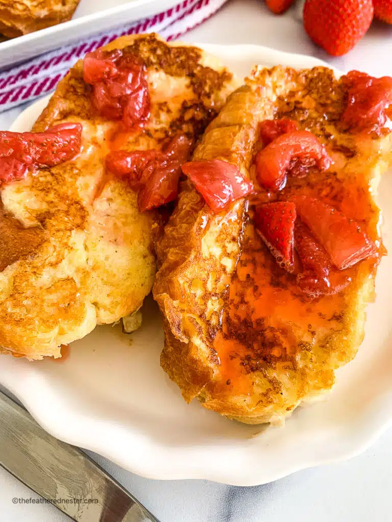two slices of strawberry French toast on a plate, close up.