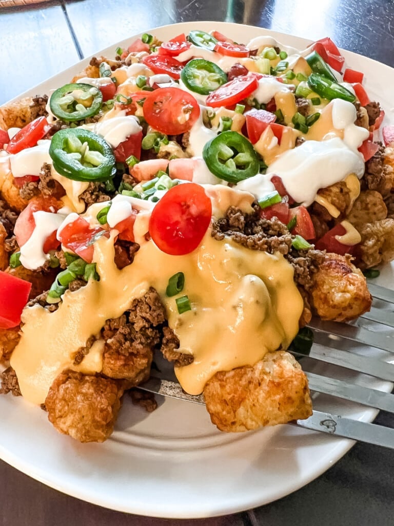 Serving tachos from a white platter.