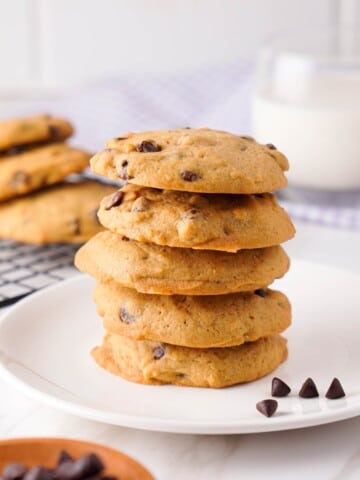 Stack of freshly baked Sam's Club chocolate chip cookies on a plate.