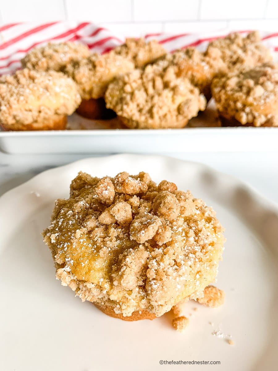 single serving coffee cakes on a serving tray, one on a small white plate in foreground.