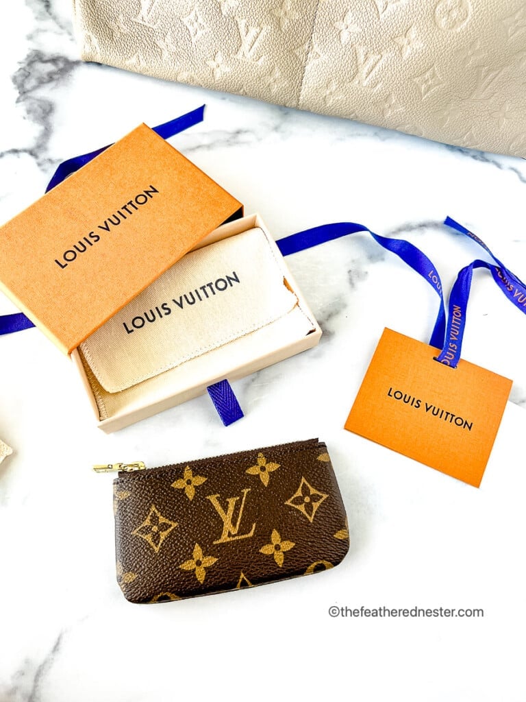 keychain wallet with a gift box, ribbon, dust bag, and Louis Vuitton gift card