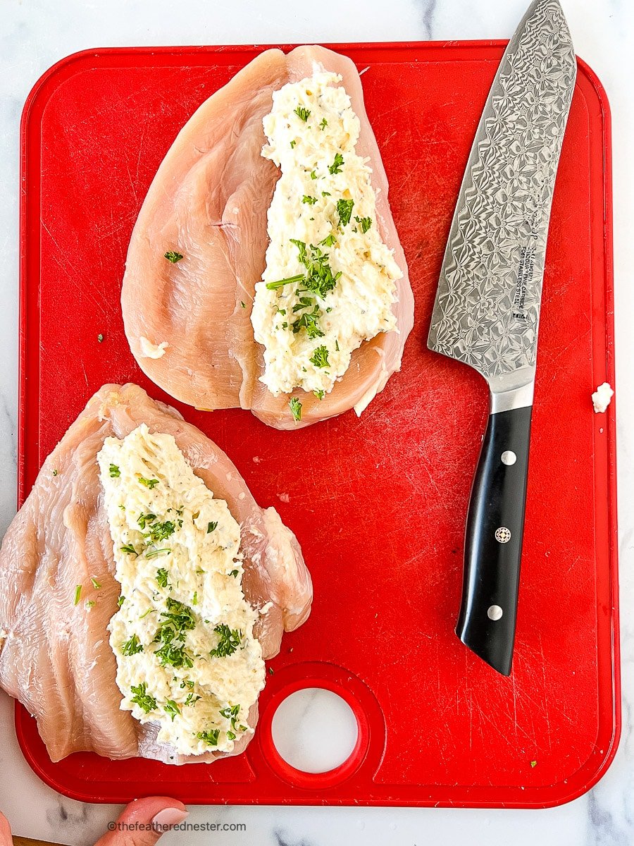 Herb and cheese filling on top of unbaked butterflied chicken breasts.