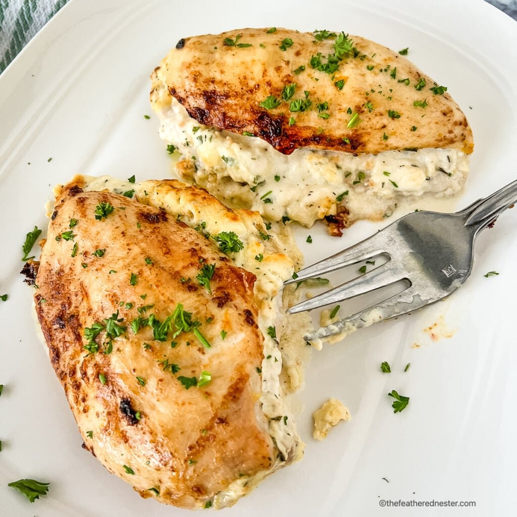 Cheese stuffed chicken breasts on a plate.