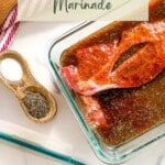 Raw pork steaks in glass dish of pork chop marinade. with writings in the top and bottom part