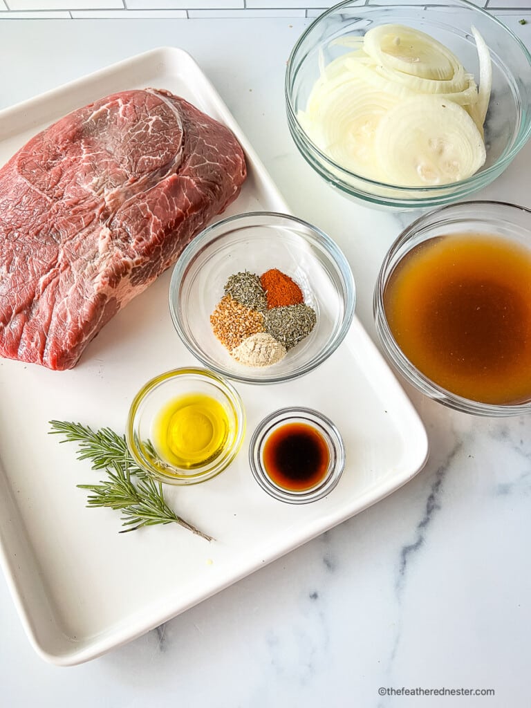 Sirloin tip roast slow cooker recipe ingredients: boneless beef roast, onions, stock, and seasonings.