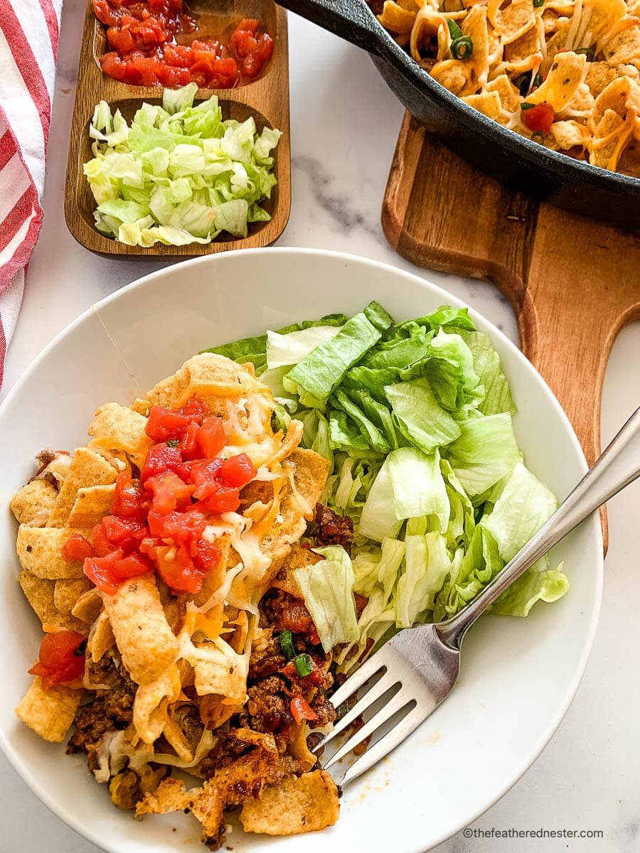 Serving of walking taco bake on a small white plate.