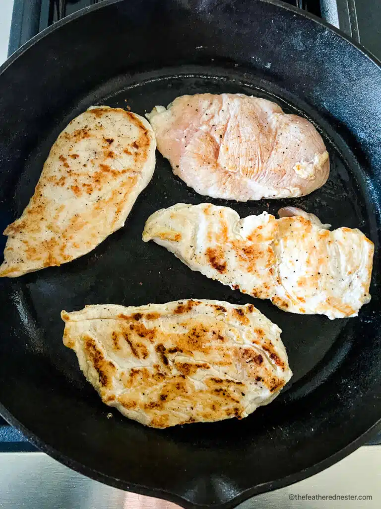Making a skillet chicken recipe on stove.