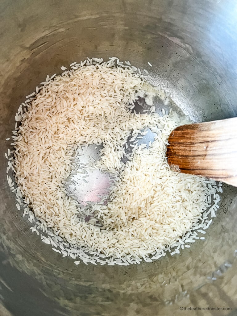 Sautéing grains of white Basmati for vegetable rice recipe.