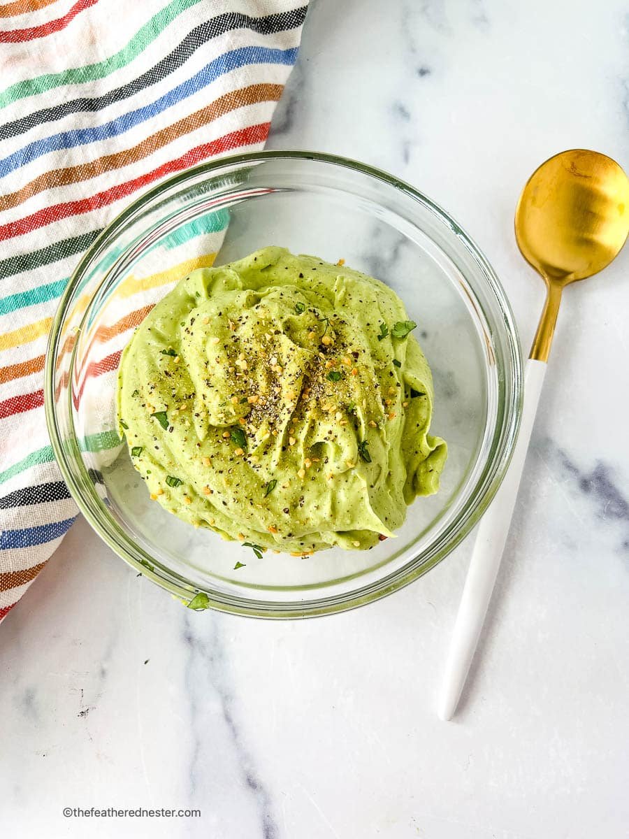 homemade avocado crema in a glass serving dish.