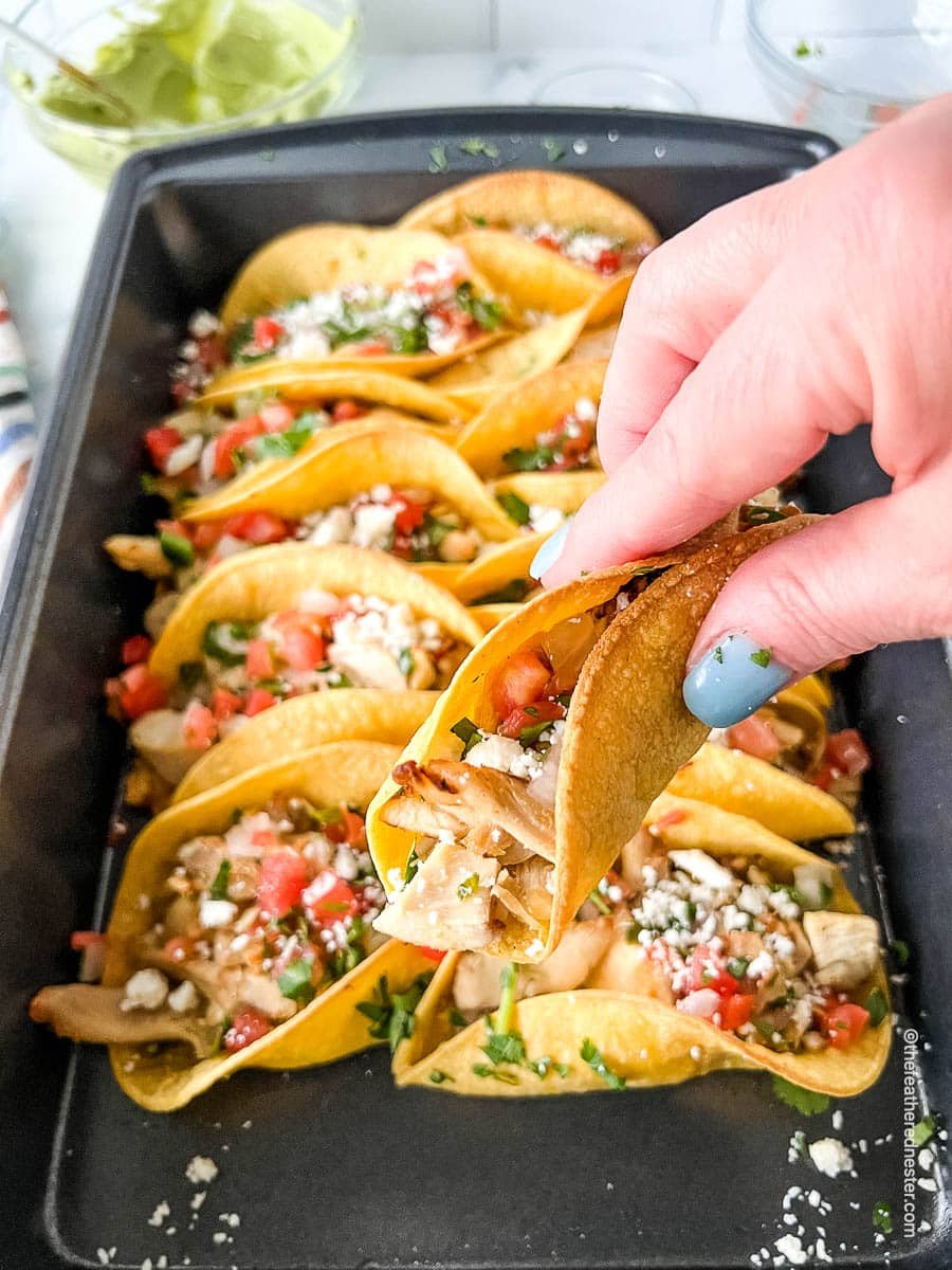 Authentic street taco in a woman's hand, close up.