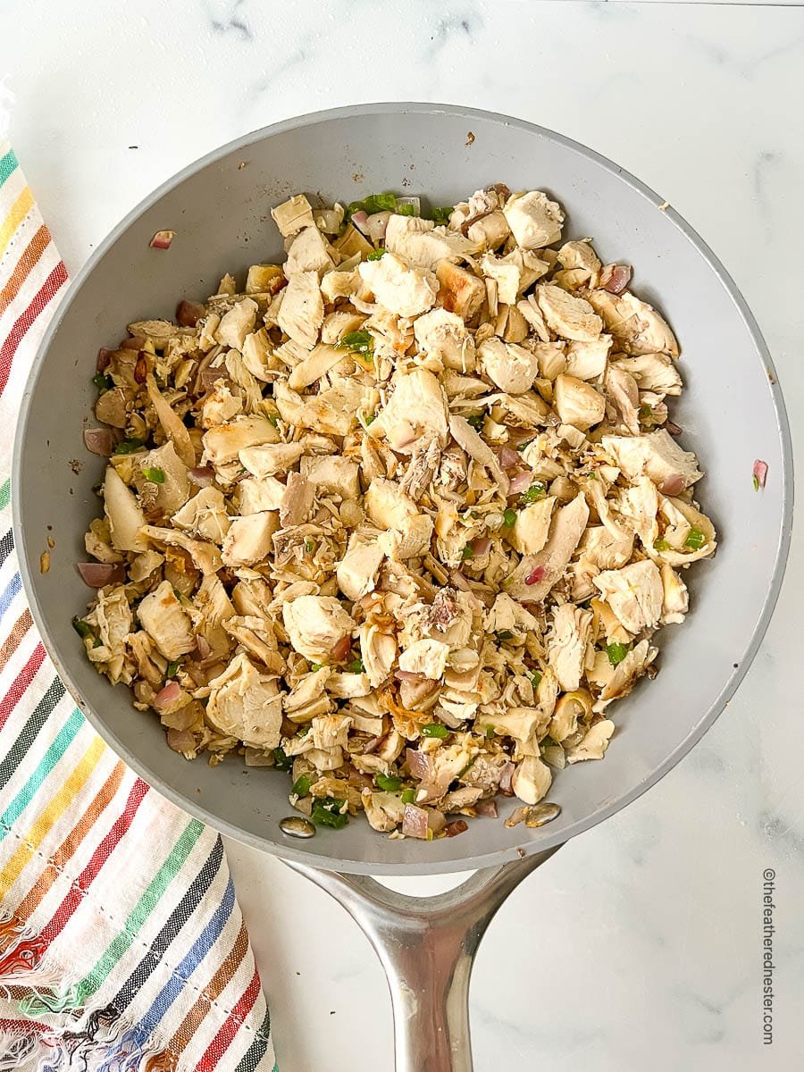 Bite sized pieces of Mexican seasoned white meat in a sauté pan.