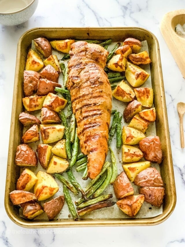 Pork tenderloin and vegetables on sheet pan.