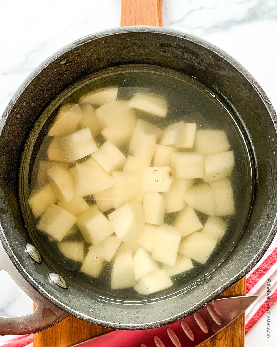 Diced white potatoes in pot of water.